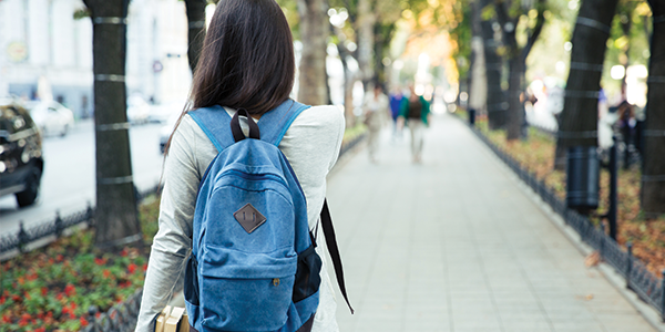 Young woman walking down path